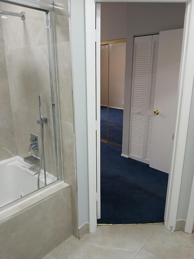 bathroom featuring tile patterned flooring and enclosed tub / shower combo