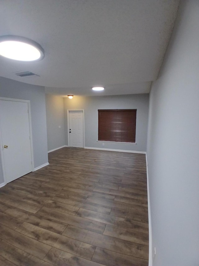 spare room with dark wood-type flooring