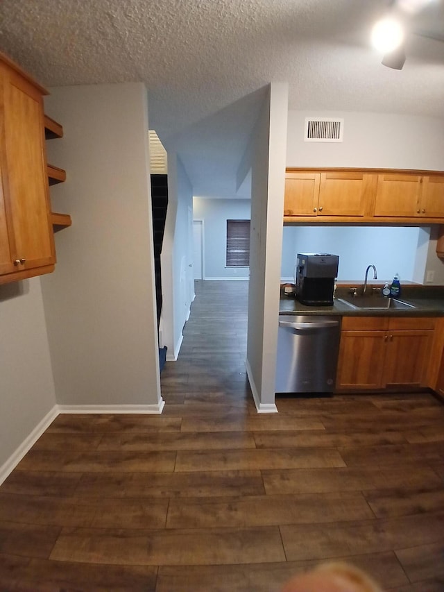 kitchen featuring dishwasher, ceiling fan, dark hardwood / wood-style flooring, sink, and a textured ceiling