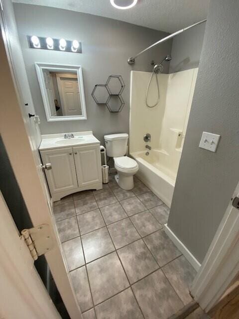 full bathroom with bathtub / shower combination, vanity, toilet, and tile patterned flooring