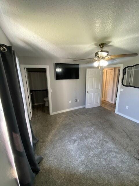 interior space with ceiling fan, carpet, and a textured ceiling