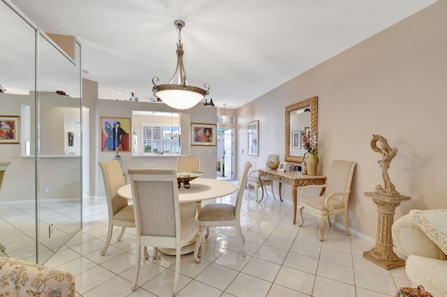 dining room featuring light tile patterned flooring and baseboards