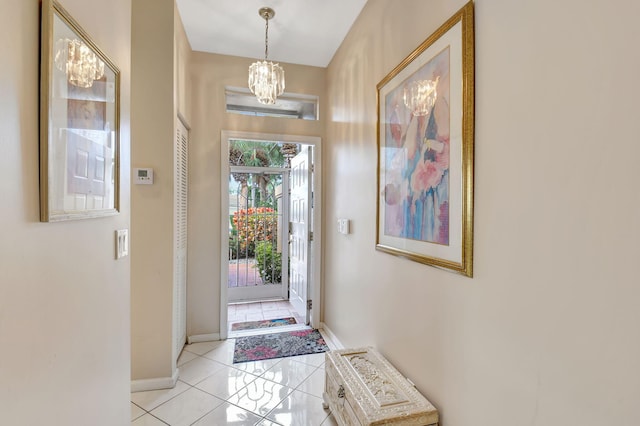 tiled entryway featuring a chandelier