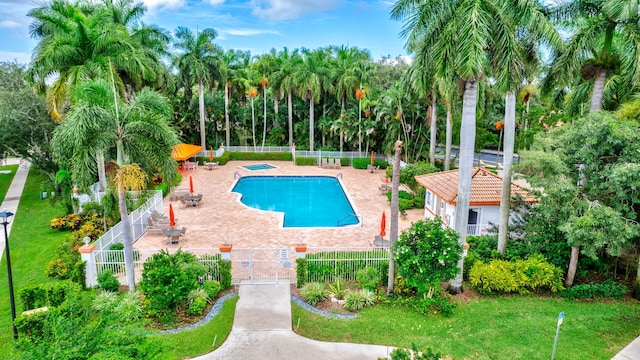 pool featuring a lawn, a patio area, and fence private yard