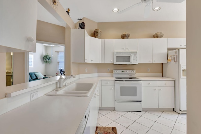 kitchen featuring light tile patterned floors, white appliances, white cabinetry, and sink