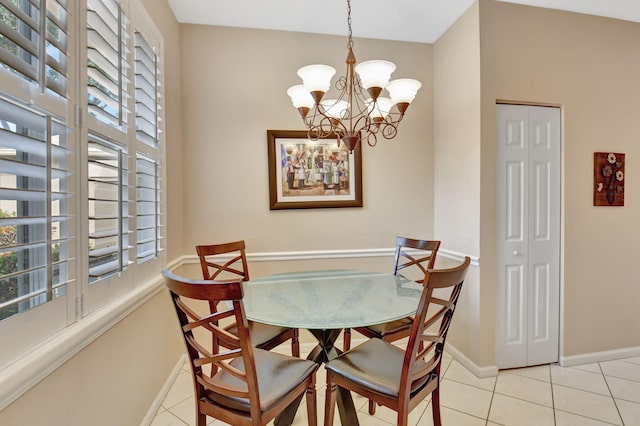 tiled dining area with a chandelier