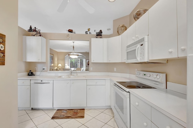 kitchen featuring white appliances, ceiling fan, light countertops, a sink, and light tile patterned flooring