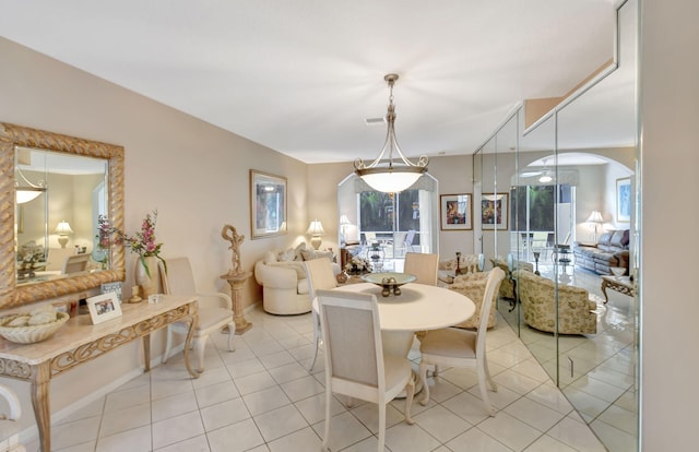 tiled dining area featuring a healthy amount of sunlight