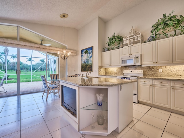 kitchen featuring light tile patterned floors, electric range, decorative light fixtures, and a kitchen island with sink