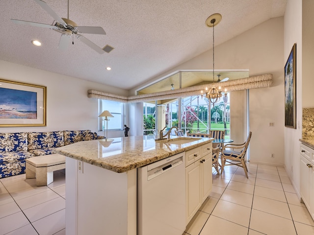 kitchen with pendant lighting, dishwasher, lofted ceiling, a kitchen island with sink, and a textured ceiling