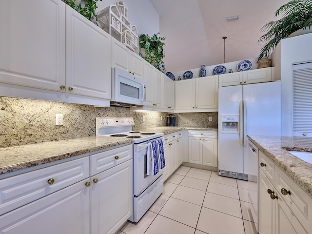 kitchen with decorative backsplash, light stone counters, white appliances, light tile patterned floors, and white cabinetry