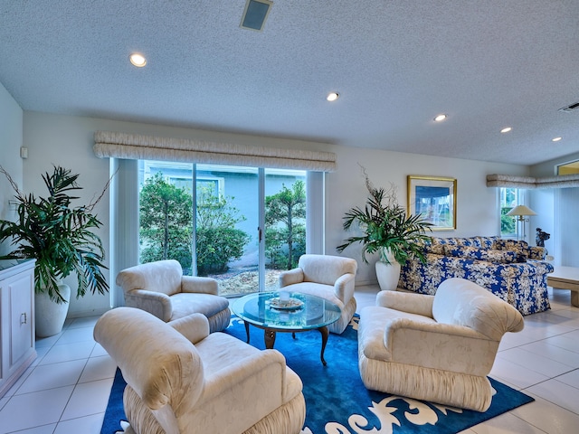 living room featuring light tile patterned floors and a textured ceiling