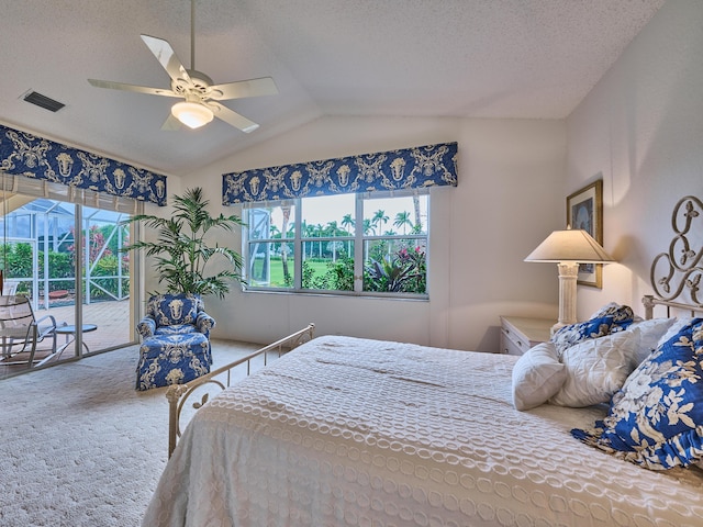 carpeted bedroom with access to exterior, ceiling fan, vaulted ceiling, a textured ceiling, and multiple windows