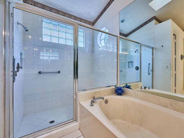 bathroom with tile patterned flooring, a textured ceiling, lofted ceiling with skylight, and independent shower and bath