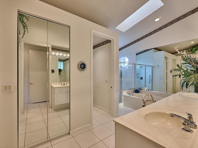 bathroom featuring separate shower and tub, tile patterned flooring, vanity, and vaulted ceiling with skylight