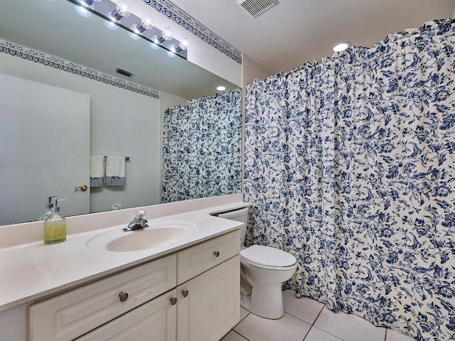 bathroom featuring toilet, vanity, and tile patterned floors