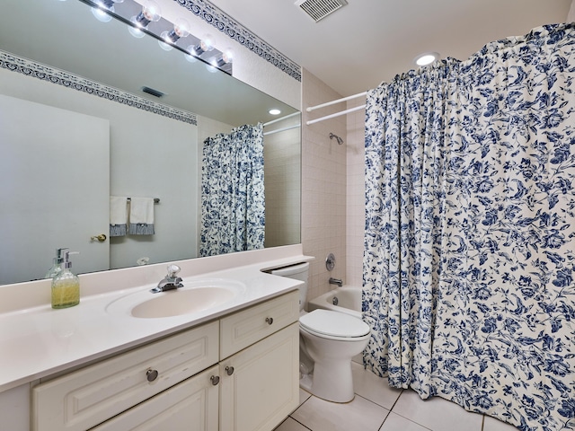 bathroom with tile patterned flooring, vanity, and toilet