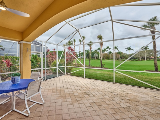 view of patio with ceiling fan and a lanai