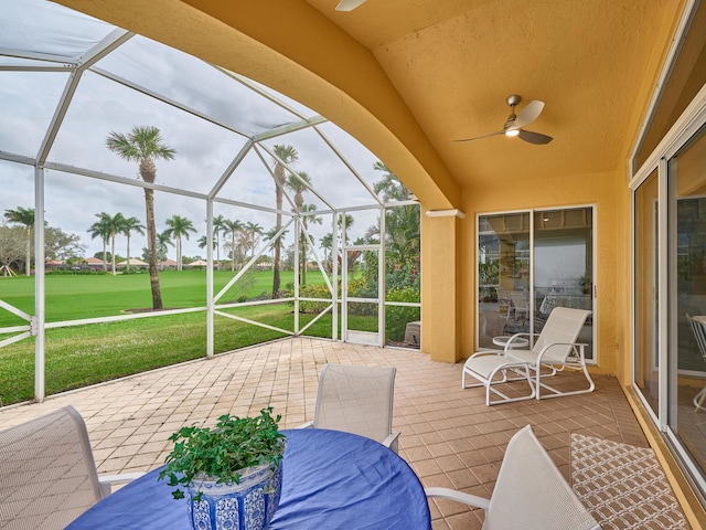 view of patio / terrace with ceiling fan and a lanai