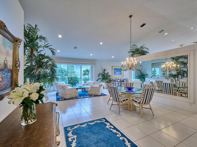 tiled dining room featuring a textured ceiling and a chandelier