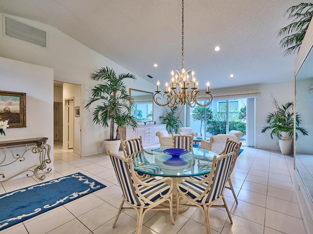 dining space with a notable chandelier, light tile patterned floors, a textured ceiling, and vaulted ceiling