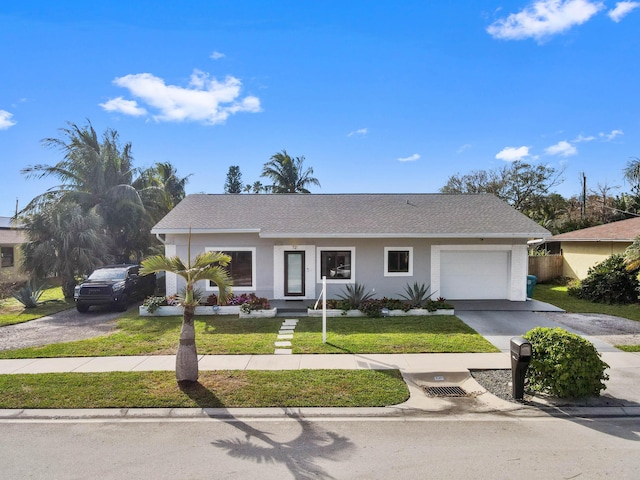 ranch-style house featuring a garage and a front yard