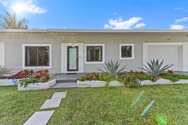 view of front of property with a garage and a front yard