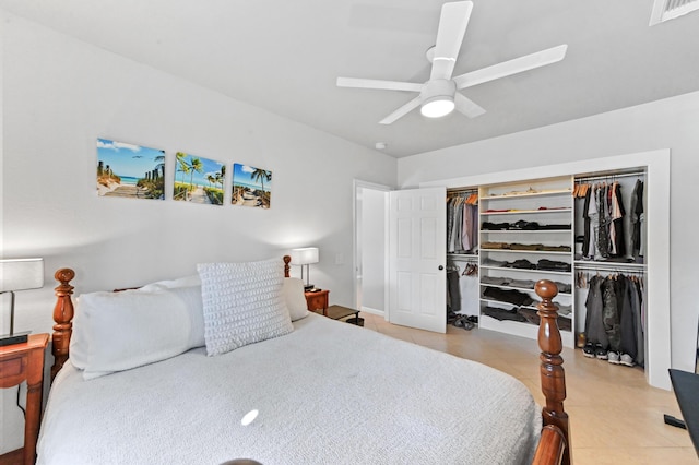 bedroom featuring ceiling fan, a closet, and light tile patterned floors