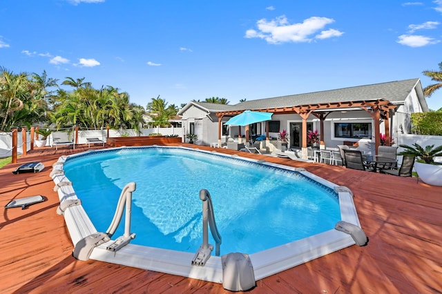 view of swimming pool with a wooden deck