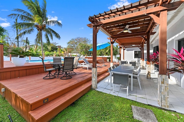 wooden terrace with ceiling fan, a pergola, and a swimming pool