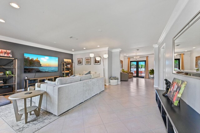 living room with light tile patterned flooring, crown molding, french doors, and a notable chandelier