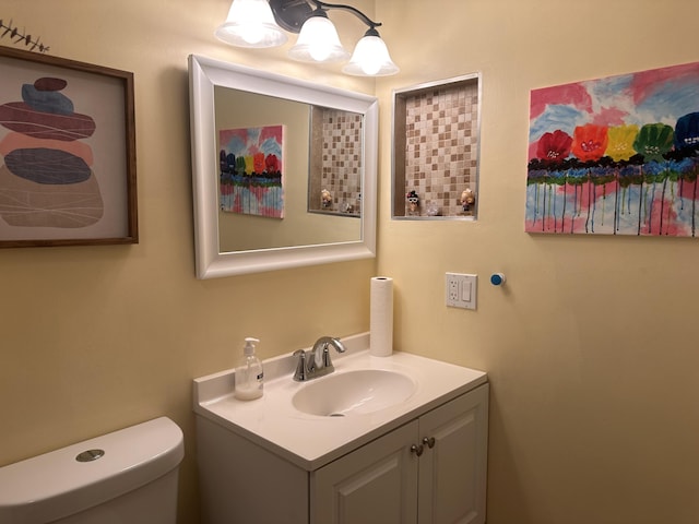 bathroom with toilet and vanity