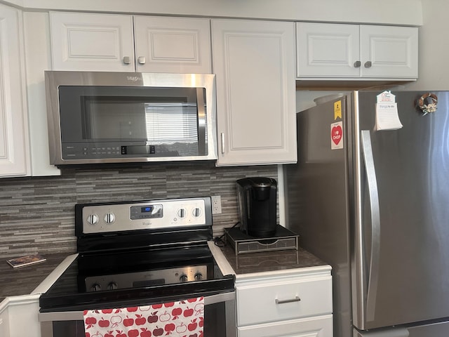 kitchen featuring tasteful backsplash, white cabinets, and stainless steel appliances