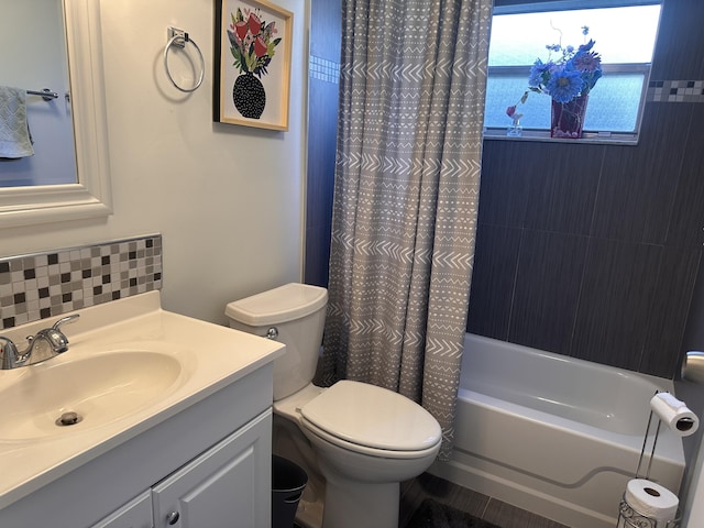 full bathroom featuring toilet, shower / bath combo, tasteful backsplash, and vanity