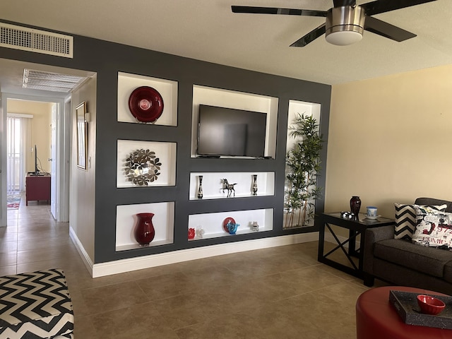 living room featuring ceiling fan and tile patterned flooring