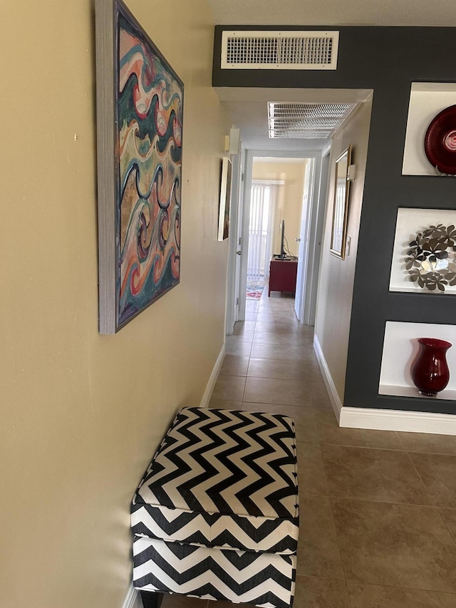 hallway featuring dark tile patterned floors