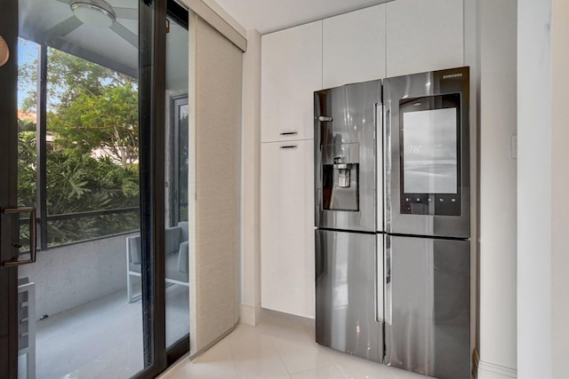 kitchen with white cabinets, stainless steel refrigerator with ice dispenser, and light tile patterned floors