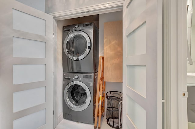 laundry area featuring stacked washer / dryer