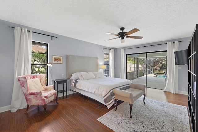 bedroom with access to exterior, ceiling fan, dark hardwood / wood-style flooring, and a textured ceiling