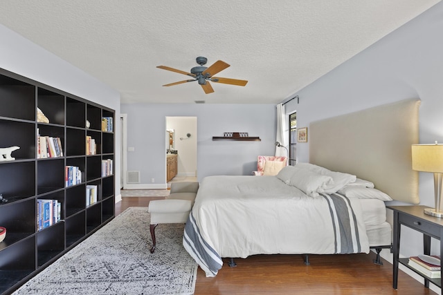 bedroom featuring a textured ceiling, ceiling fan, wood-type flooring, and ensuite bathroom