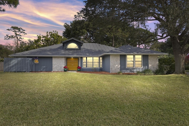 ranch-style house with a front lawn