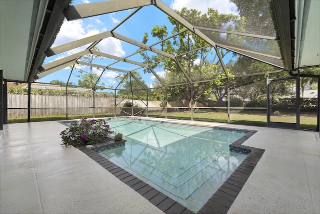 view of pool with a lanai and a patio