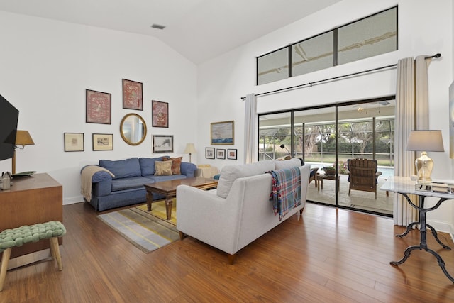 living room featuring hardwood / wood-style floors and high vaulted ceiling