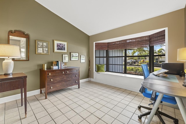 office space with lofted ceiling and light tile patterned flooring