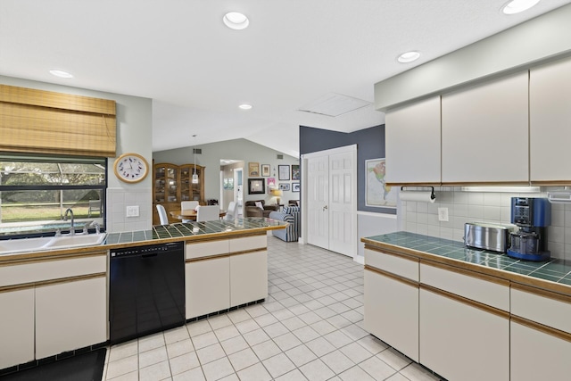 kitchen featuring sink, black dishwasher, backsplash, tile countertops, and white cabinets