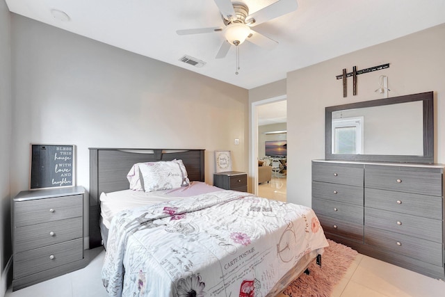 tiled bedroom with ceiling fan