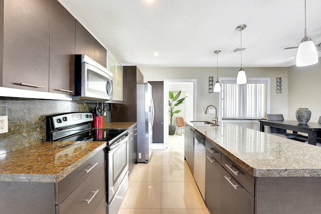 kitchen with decorative backsplash, sink, decorative light fixtures, and appliances with stainless steel finishes