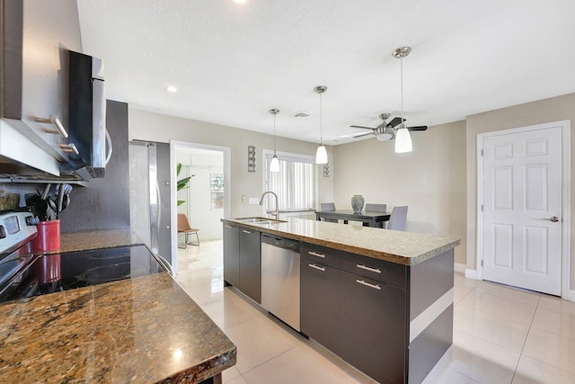 kitchen featuring a spacious island, sink, ceiling fan, light tile patterned floors, and appliances with stainless steel finishes