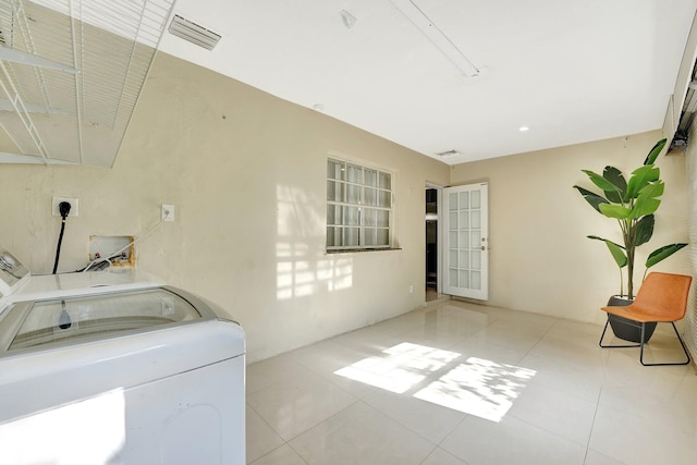 laundry room with light tile patterned floors and washing machine and clothes dryer