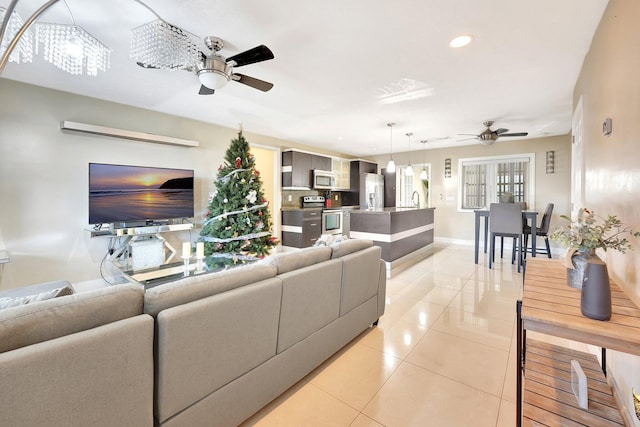 tiled living room featuring ceiling fan and sink